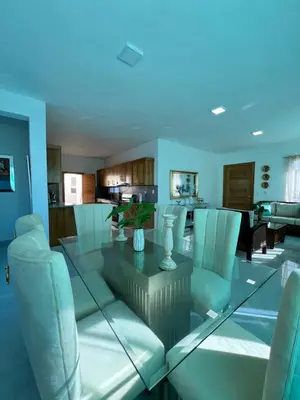 a dining room with a glass table and chairs at Villa Angel in San Felipe de Puerto Plata