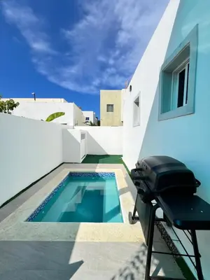 a swimming pool on the roof of a house at Villa Angel in San Felipe de Puerto Plata
