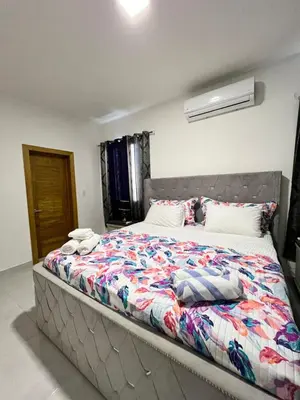 a bedroom with a large bed with towels on it at Villa Angel in San Felipe de Puerto Plata