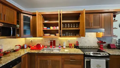 a kitchen with wooden cabinets and a sink at Hispaniola Beach Retreat in Sosúa