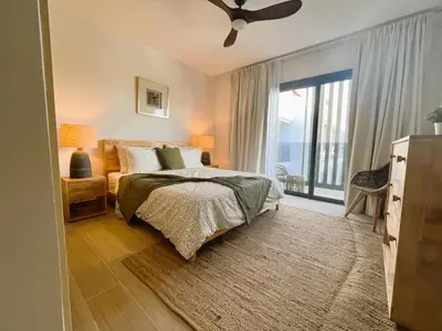 a bedroom with a bed and a large window at Exclusivo penthouse con piscina en Playa Bávaro in Punta Cana
