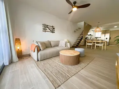 a living room with a couch and a table at Exclusivo penthouse con piscina en Playa Bávaro in Punta Cana