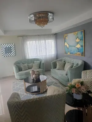 a living room with blue couches and a chandelier at El apartamento que tu necesita para disfrutar tu vacaciones in Villa Mella