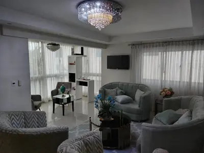 a living room with couches and a chandelier at El apartamento que tu necesita para disfrutar tu vacaciones in Villa Mella