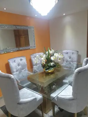 a dining room with a glass table and chairs at El apartamento que tu necesita para disfrutar tu vacaciones in Villa Mella