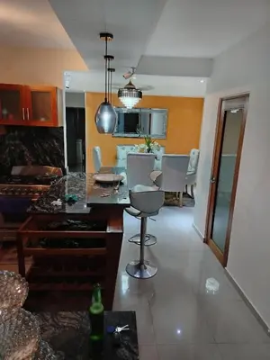 a kitchen and living room with a table and chairs at El apartamento que tu necesita para disfrutar tu vacaciones in Villa Mella