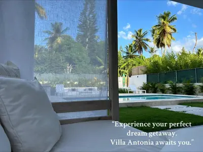 a bedroom with a window with a view of a pool at Villa Antonia Spectacular Private Stay with Pool, Just Steps from the Beach, Housekeeping & Kitchen in Exclusive Gated Community in Las Terrenas