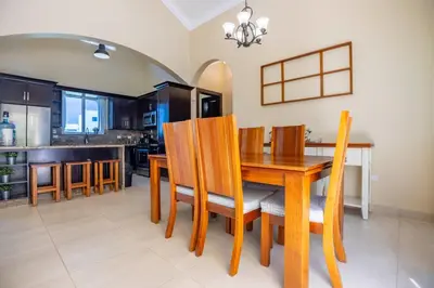a kitchen and dining room with a wooden table and chairs at Sosua Ocean Village, Villa 11, Garden Dream in Sosúa