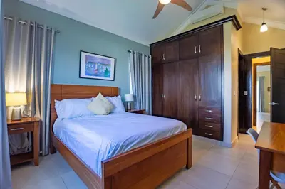 a bedroom with a large bed with blue walls at Sosua Ocean Village, Villa 11, Garden Dream in Sosúa