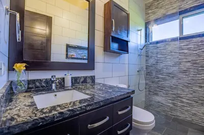 a bathroom with a sink and a toilet and a shower at Sosua Ocean Village, Villa 11, Garden Dream in Sosúa
