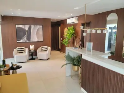 a lobby of a hotel with chairs and a counter at Luxury Apartment Downtown in Santiago de los Caballeros