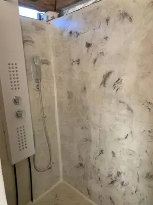 a shower in a bathroom with a marble wall at EL Cielo de Cana in Las Terrenas