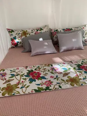 two beds with pillows and a laptop on top of them at EL Cielo de Cana in Las Terrenas