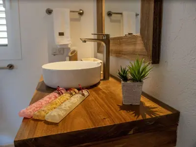 a bathroom counter with a sink and some food on it at JandalaVillage in Las Terrenas