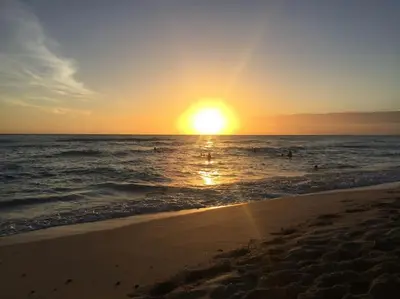 a sunset on a beach with the ocean at Ballenas beach C8 in Las Terrenas