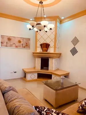 a living room with a couch and a fireplace at Cerca del divino niño I WiFi I TV in Constanza