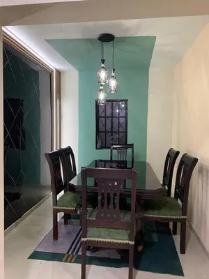 a dining room with a green table and chairs at Cerca del divino niño I WiFi I TV in Constanza