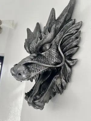 a metal fish wall decoration on a wall at Level suites Penthouse in Sosúa