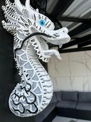 a white statue of a dragon on a wall at Level suites Penthouse in Sosúa