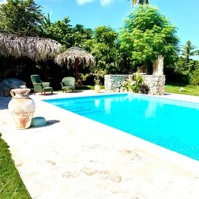 a swimming pool with a vase next to a house at Casa Del Sol in El Limón