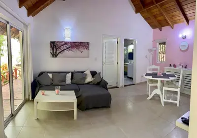 a living room with a couch and a table at Chalet tropical au cœur de Las Terrenas in Las Terrenas