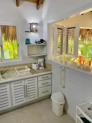 a white kitchen with a sink and a toilet at Chalet tropical au cœur de Las Terrenas in Las Terrenas