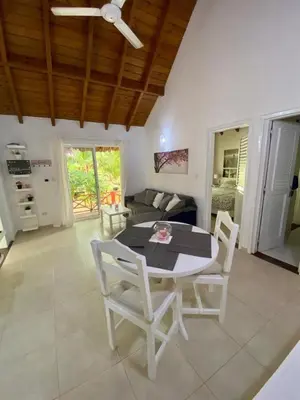 a living room with a table and chairs at Chalet tropical au cœur de Las Terrenas in Las Terrenas