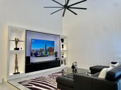 a living room with a large flat screen tv at Casa black and white frente al mar in Las Galeras