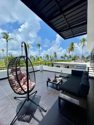 a swing on the roof of a house at Casa black and white frente al mar in Las Galeras