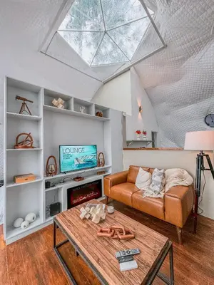 a living room with a couch and a table at The Domes Jarabacoa in Jarabacoa
