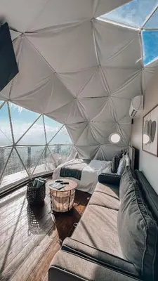 a room with a tent with two beds and a couch at The Domes Jarabacoa in Jarabacoa