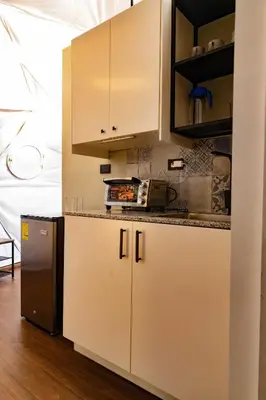 a kitchen with white cabinets and a counter at The Domes Jarabacoa in Jarabacoa
