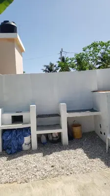 a white bench sitting next to a white wall at Villa el real los patos in Los Patos