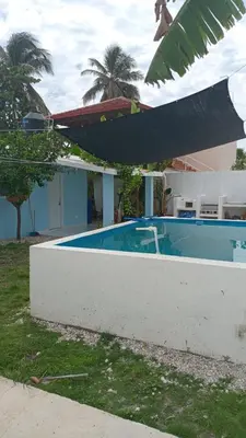 a swimming pool in front of a house at Villa el real los patos in Los Patos