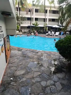 a swimming pool in front of a hotel at Acuario residencial 1 in La Viva