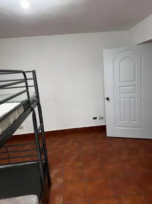 a room with a bunk bed and a white door at DiNancyCasolare - La Colonia, SC in Cambita Garabitos