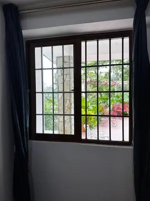 a window in a room looking out at a garden at DiNancyCasolare - La Colonia, SC in Cambita Garabitos