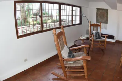 a room with two chairs and a table and a window at DiNancyCasolare - La Colonia, SC in Cambita Garabitos