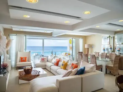 a living room with a white couch and a table at SuiteDelux Oceanview Marbella 3BDR in Juan Pedro