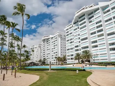 a large apartment building with a swimming pool and palm trees at SuiteDelux Oceanview Marbella 3BDR in Juan Pedro