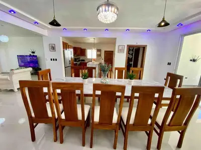 a dining room with a table and chairs at Modern Vacation Paradise Villa with Private Pool in Sosúa