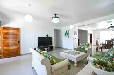 a living room with two couches and a tv at Modern Vacation Paradise Villa with Private Pool in Sosúa