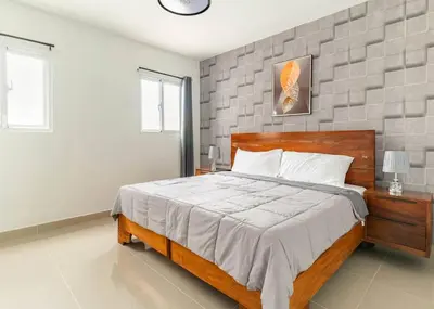 a bedroom with a large wooden bed in it at Modern Vacation Paradise Villa with Private Pool in Sosúa