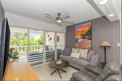 a living room with a couch and a ceiling fan at El Neptuno Residencial, Sosua in Sosúa