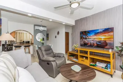 a living room with a couch and a table at El Neptuno Residencial, Sosua in Sosúa