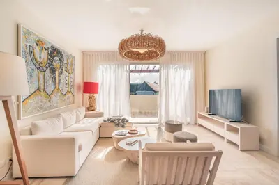 a living room with a white couch and a tv at Exceptional apartment nearby beach at Portillo in Las Terrenas