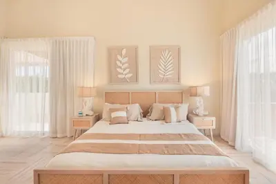 a bedroom with a large bed and two windows at Exceptional apartment nearby beach at Portillo in Las Terrenas