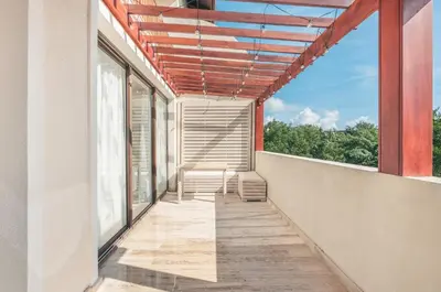 an outdoor balcony with chairs and a window at Exceptional apartment nearby beach at Portillo in Las Terrenas