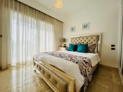 a bedroom with a large bed with blue pillows at Paradise Pool Front and Beach Condo at Punta Cana in Punta Cana