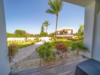 a view from the outside of a house with a palm tree at Encuentro Studio surf kitesurf Residencia Aris in Cabarete